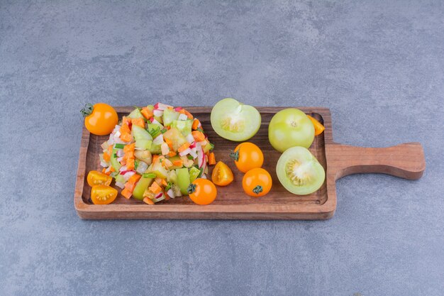 Vegetable salad with seasonal foods in a wooden dish