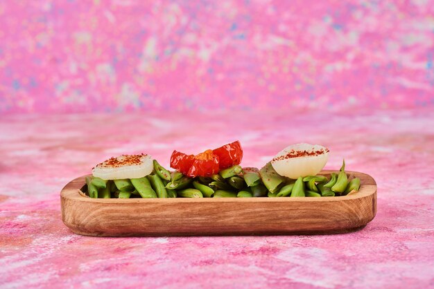 Vegetable salad in a wooden platter.