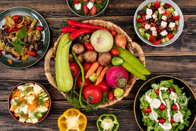 Vegetable salads on wooden table top view concept