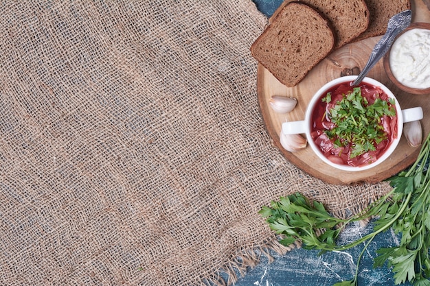 Vegetable soup in tomato sauce with herbs and bread.