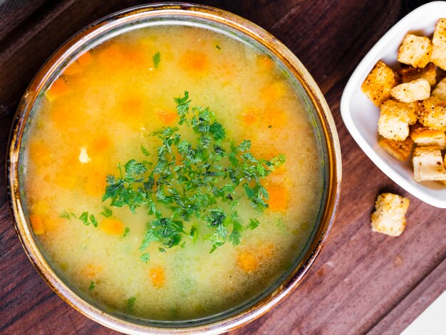 Vegetable soup topped with chopped herbs