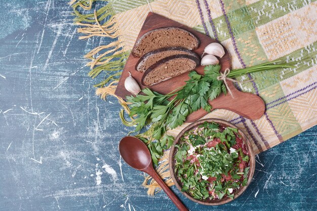 Vegetable soup with herbs and spices served with dark bread.