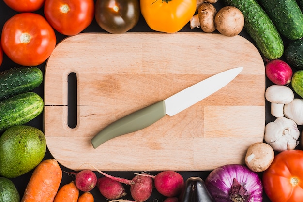 Vegetables around cutting board