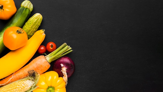 Vegetables assortment on dark background with copy space