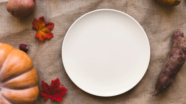 Vegetables and leaves near plate