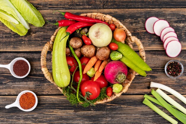 Vegetables for salad red chili pepper onion dill cherry tomato cabbage mushroom in a basket