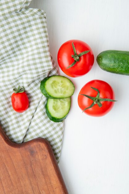 vegetables with cutting board on white table