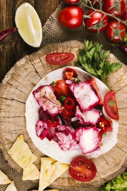 Vegetables on wooden plate top view