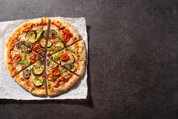 Vegetarian pizza with zucchini tomato peppers and mushrooms