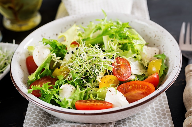 Vegetarian salad with cherry tomato, mozzarella and lettuce.