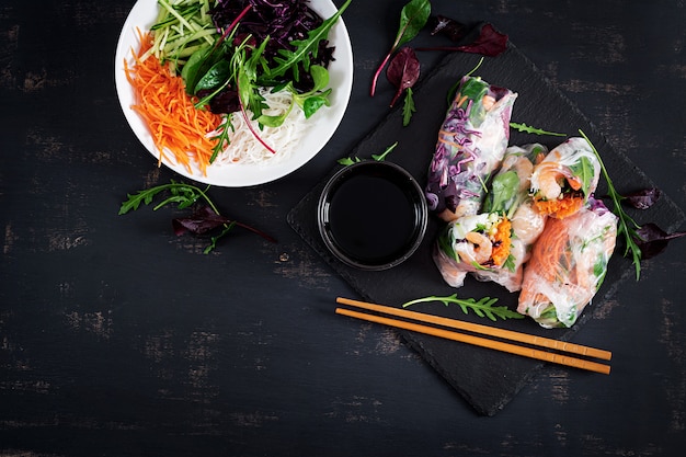 Vegetarian vietnamese spring rolls with spicy shrimps, prawns, carrot, cucumber, red cabbage and rice noodle