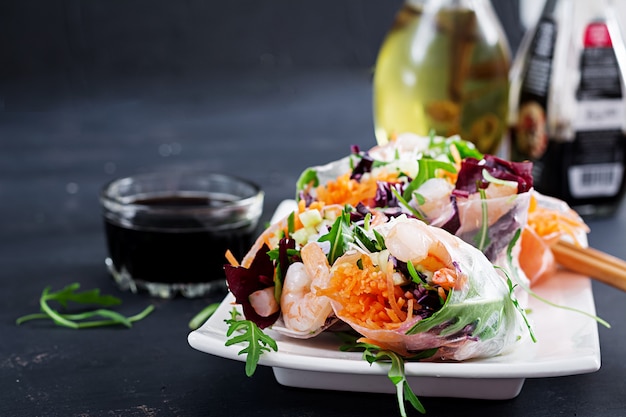 Vegetarian vietnamese spring rolls with spicy shrimps, prawns, carrot, cucumber, red cabbage and rice noodle