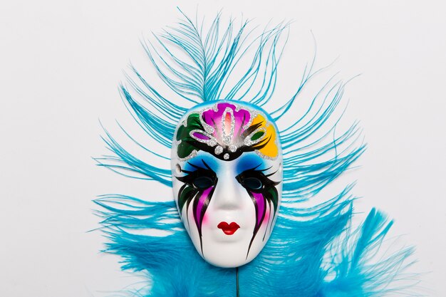 Venetian mask on blue feather