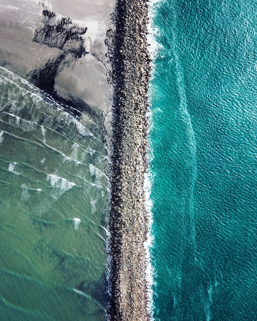 Vertical aerial shot of Columbia River meeting the Pacific Ocean at Fort Stevens