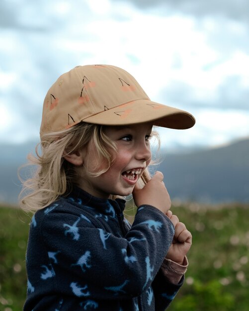 Vertical blonde girl wearing a brown cap