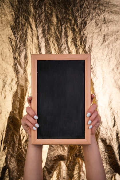 Vertical chalkboard mock-up held in hand