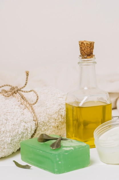 Free photo vertical close-up shot olive oil with soap bar