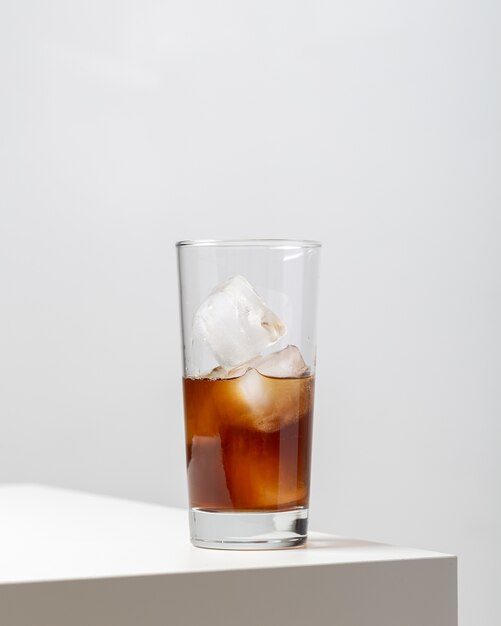 Vertical closeup of a glass of ice tea on the table