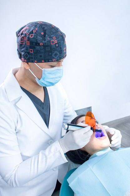 Vertical closeup of the orthodontist checking the patient's teeth