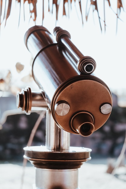 Vertical closeup shot of a city telescope