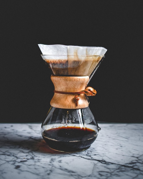 Vertical closeup shot of filtered coffee on a table