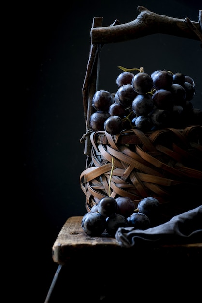 Vertical closeup shot of grape berries in a basket