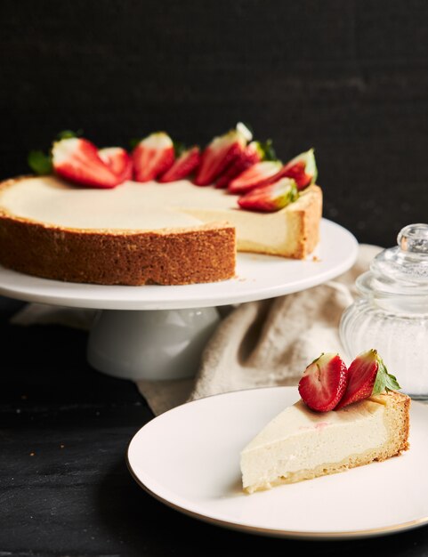 Vertical closeup shot of Strawberry Cheesecake on white plate