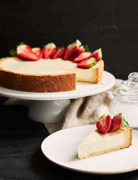 Vertical closeup shot of Strawberry Cheesecake on white plate