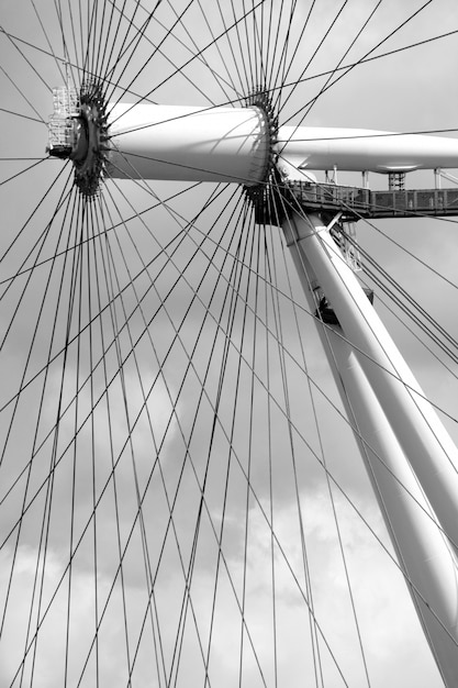 Vertical gray scale shot of merry go round and its wires