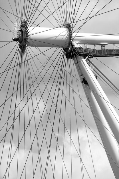 Vertical gray scale shot of merry go round and its wires