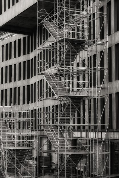 Vertical grayscale shot of a staircase outside a building used for the reconstruction