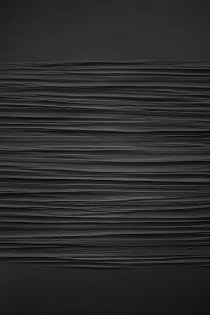 Free photo vertical grey scale shot of the patterns on a black painted wall