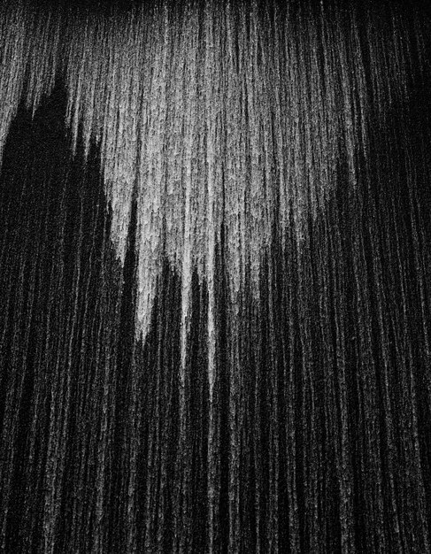 Vertical grey scale shot of a textured black and white surface