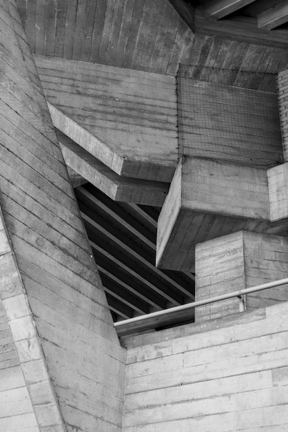 Vertical greyscale shot of an old attic with wooden ceiling