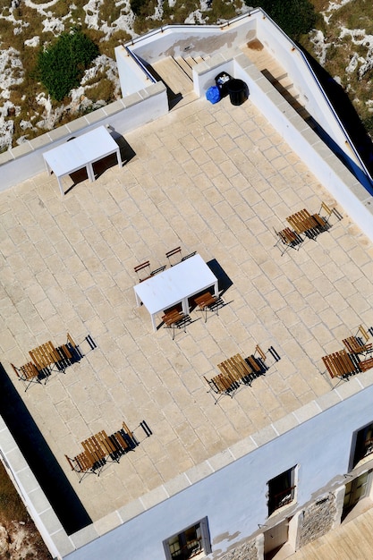 Vertical high angle shot of a cafe on a rooftop of a light blue building