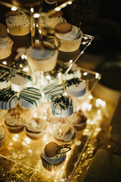 Vertical high angle shot of some cupcakes on a transparent plate