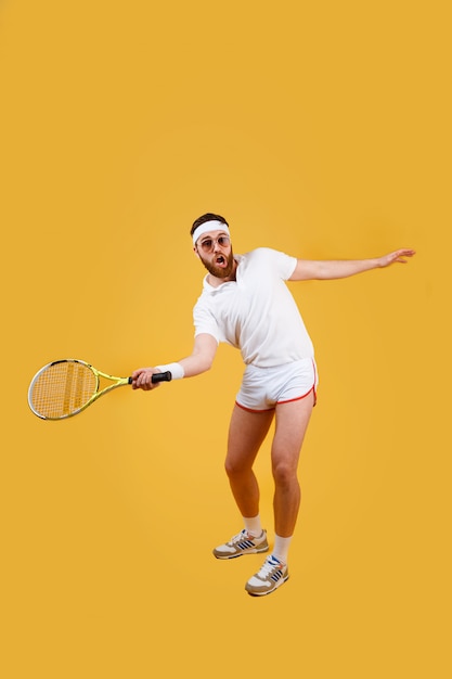 Vertical image of concentrated sportrsman playing in tennis