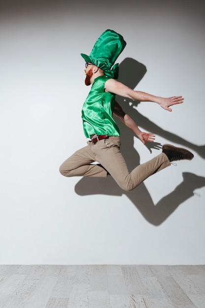 Free photo vertical image of flying man in st.patriks costume