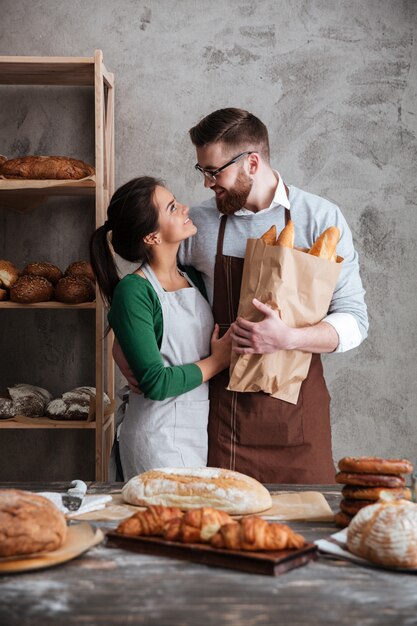 Вертикальное изображение счастливых пекарей в пекарне