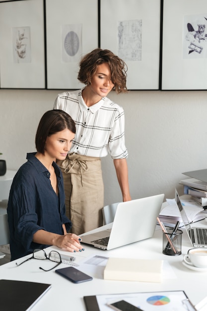 Vertical image of two women are discussing something