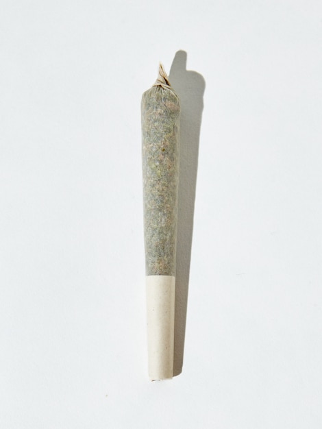 Vertical isolated shot of a marijuana blunt on white