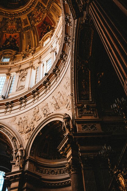 Vertical low angle shot of the beautiful paintings and carvings in an old building