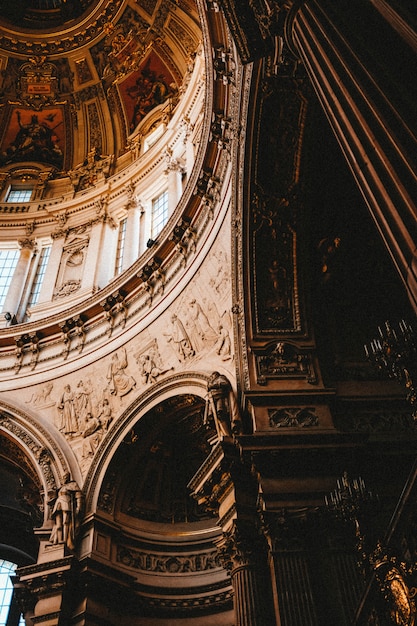 Vertical low angle shot of the beautiful paintings and carvings in an old building