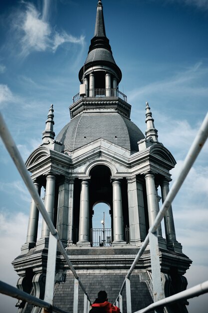 Vertical low angle shot of a building with a steeple in Roubaix, France