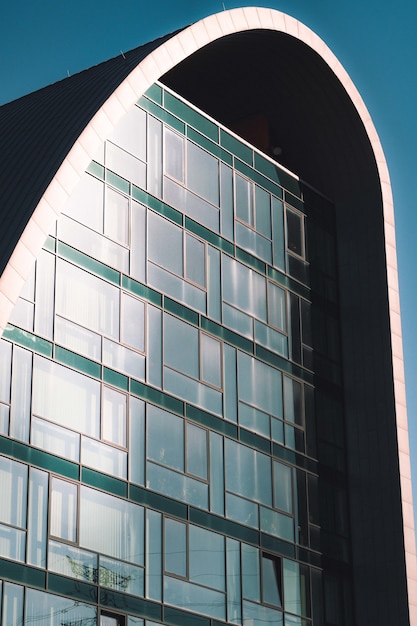 Free photo vertical low angle shot of a high rise building with glass windows