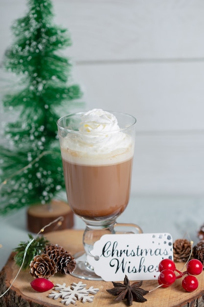 Vertical photo of creamy chocolate ice cream with Christmas decorations.