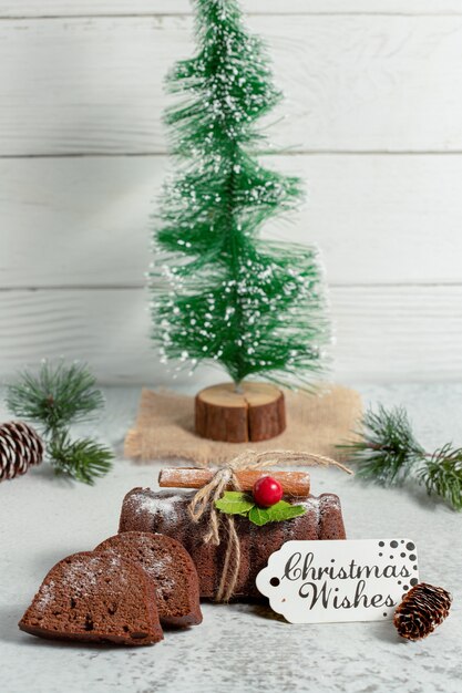 Vertical photo of fresh homemade roulette with Christmas decorations on grey surface. 