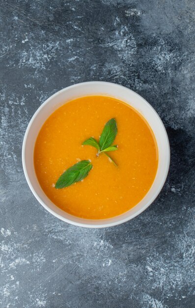 Vertical photo of tomato soup in bowl. 