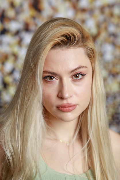 Free photo vertical photo of young blonde looking at the camera