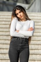 Free photo vertical photo of young lady crossed her arms and looking at the camera high quality photo